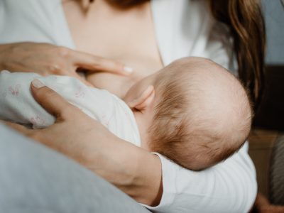 Covid vaccine and breastfeeding. Pregnancy, breastfeeding, fertility and coronavirus. Baby eating mothers milk. Mother breastfeeding baby.